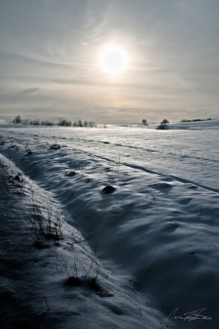 This landscape doesn't have the road or people to distract from the story, you know it is about the sun and the snow covered field.